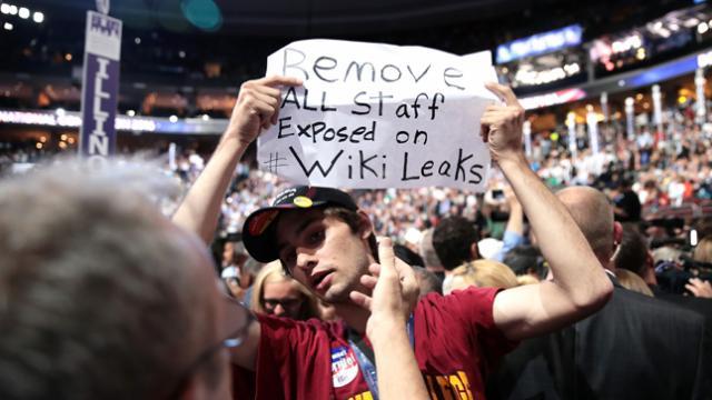Getty Image of a protestor at the 2016 DNC Convention holding a sign
