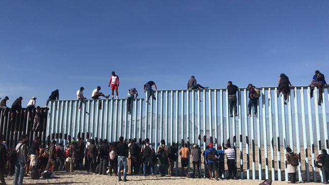 Waves Of Caravan Migrants Arrive In Tijuana, Begin Climbing San Diego ...